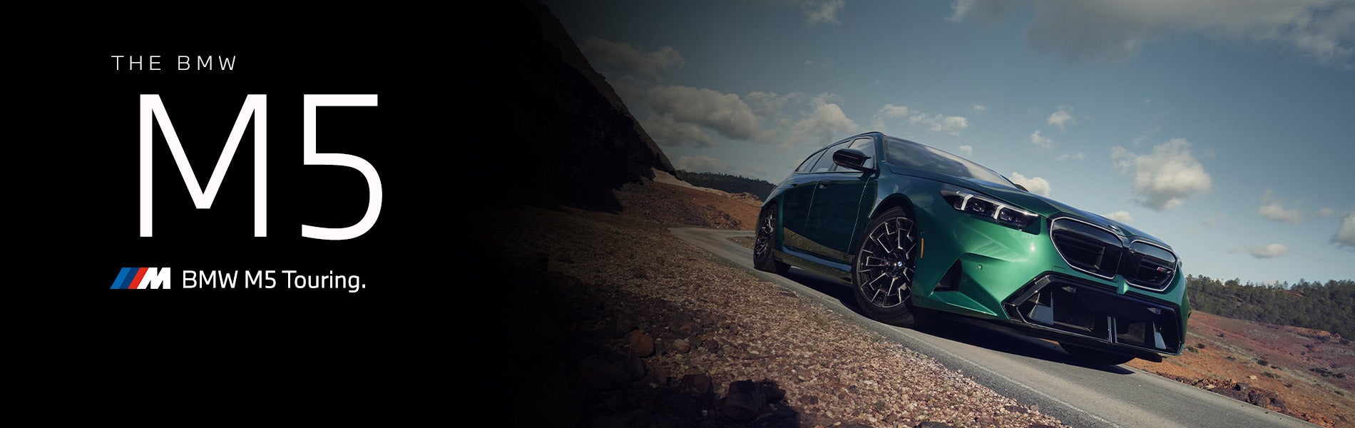 The new BMW M5 Touring in green driving down desert road | BMW of Spokane in Spokane WA